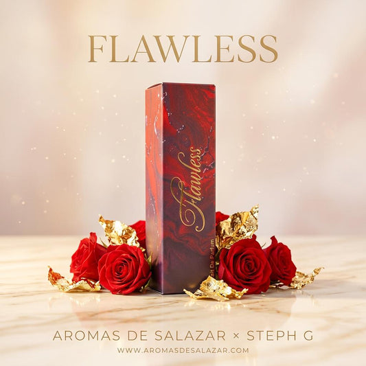 A tall rectangular perfume box in a red marbled design with gold cursive 'Flawless' lettering, displayed on a marble surface with red roses and gold foil around it. Large text at the top reads 'FLAWLESS' and the bottom reads 'AROMAS DE SALAZAR x STEPH G' with the website below.